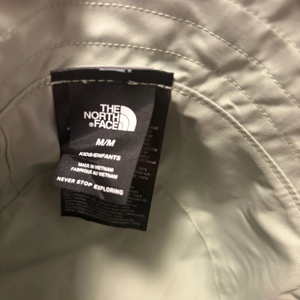 The North Face Kids Bucket Hat in Black and Olive Camo